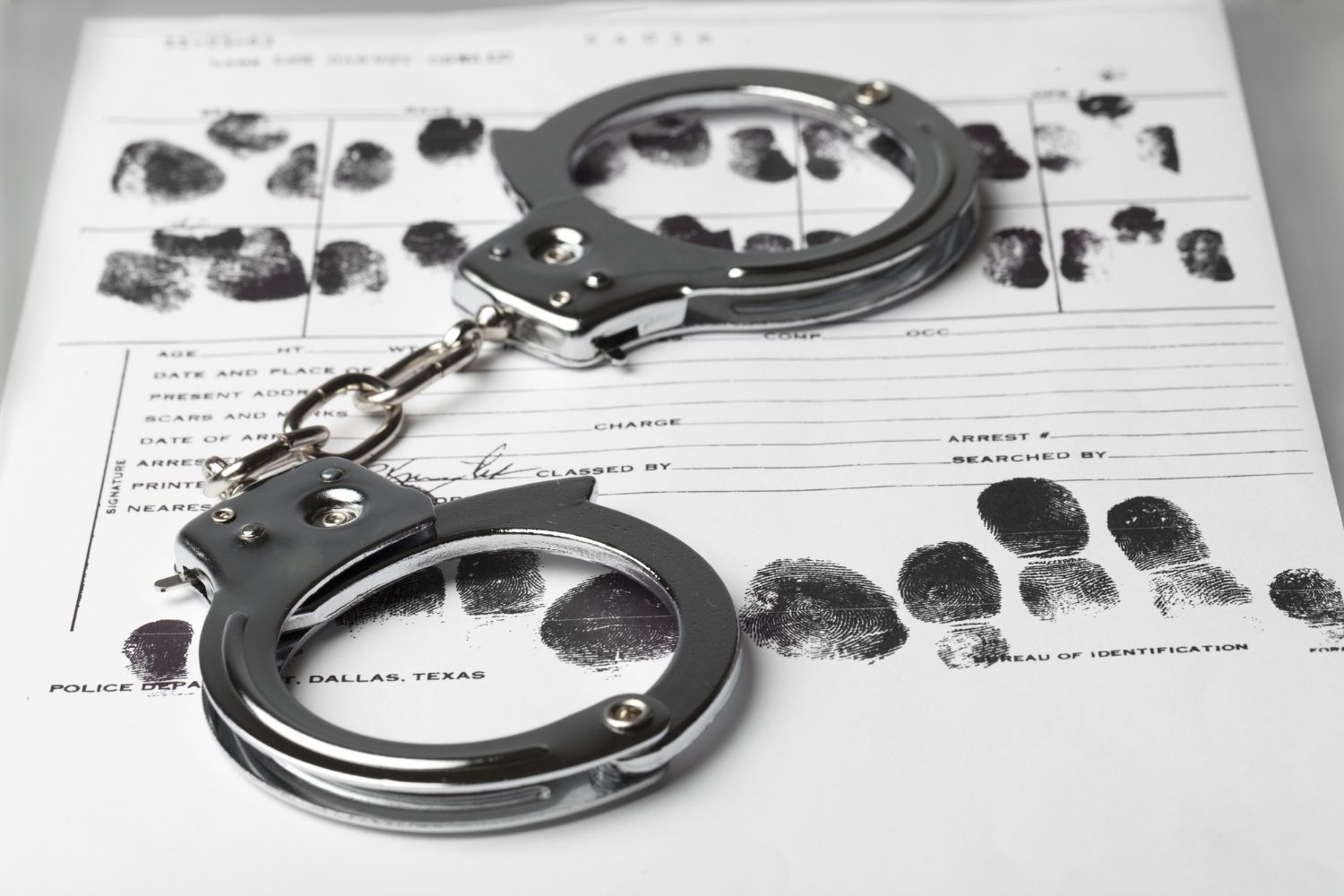 handcuffs-paper-with-fingerprints-close-up